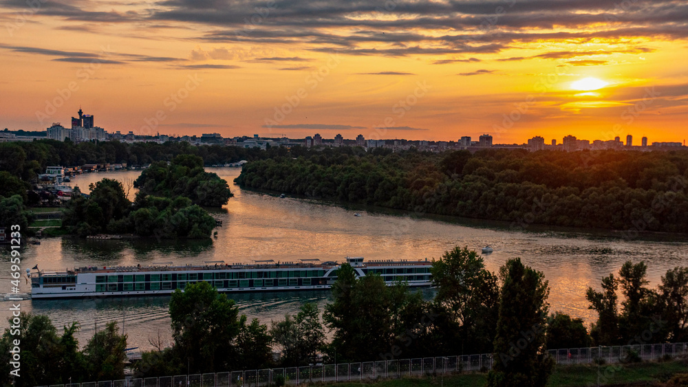 Sunset over the city with river and boat serbia belgrade