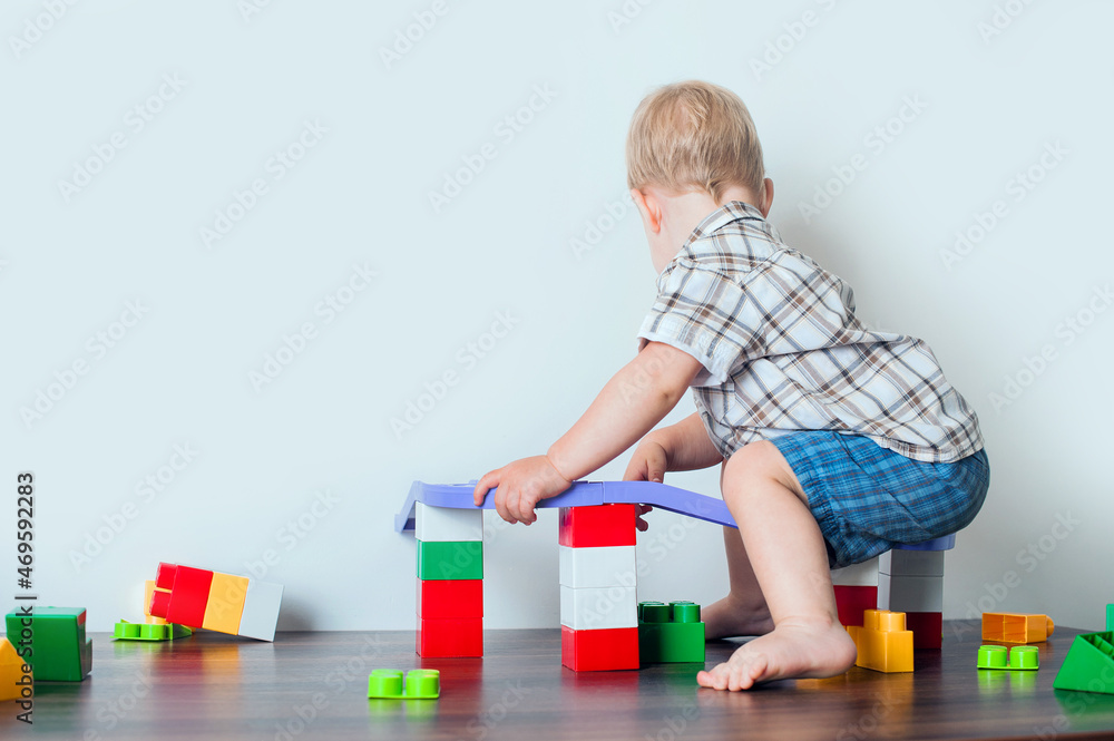 Toddler boy plays with constructor, cars, blocks close-up. Educational toys for preschool children... Toddler boy plays with constructor, cars, blocks close-up. Educational toys for preschool children...