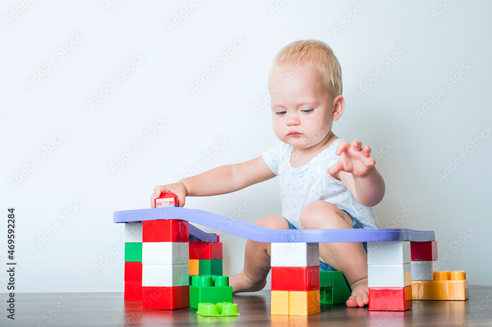 Toddler boy plays with constructor, cars, blocks close-up. Educational toys for preschool children... Toddler boy plays with constructor, cars, blocks close-up. Educational toys for preschool children...