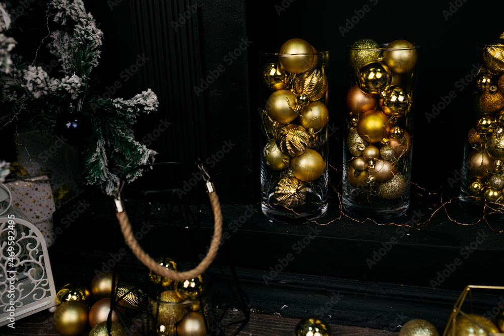 Christmas tree in the interior of the living room of a residential building in black and gold colors. festive atmosphere before Christmas. holiday card Christmas tree in the interior of the living room of a residential building in black and gold colors. festive atmosphere before Christmas. holiday card