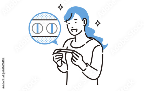 妊娠検査薬を見て喜ぶ女性