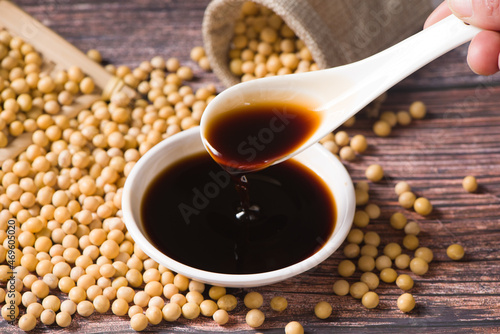 soy sauce and soybean on wooden background photo