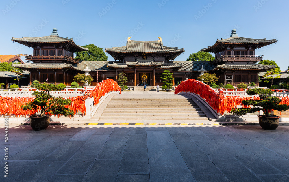 Fototapeta premium Hall of Four Heavenly Kings behind stone bridge in historic Baoshan or Treasure Mountain Serene Temple, a Buddhist temple at Luodian Town, Baoshan District, Shanghai, China.