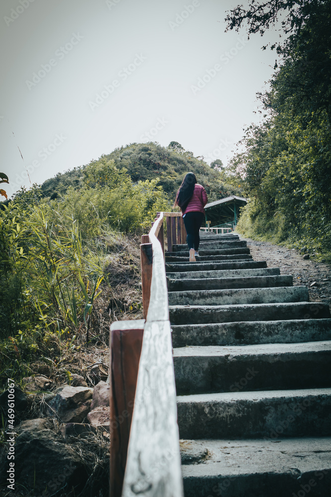 Girl climbing a rural stairway