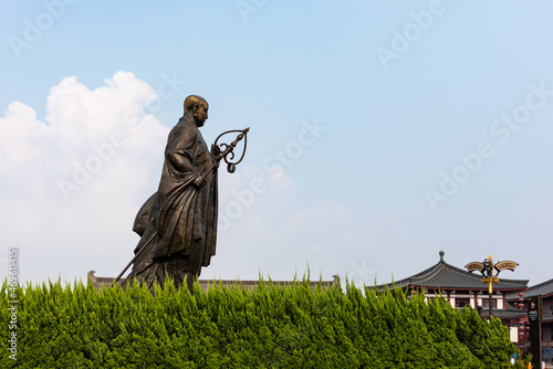 Side of the statue of famous Monk Xuanzang of Tang Dynasty in the park in front of Histrotic Giant Wild Goose Pagoda, Xi'an, Shaanxi, China, built in Tang Dynasty. UNESCO World Heritage. photo