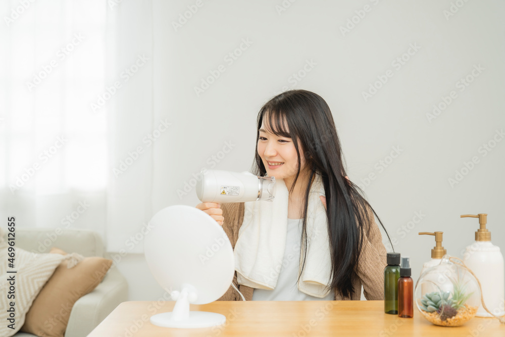 ドライヤーを使う女性
