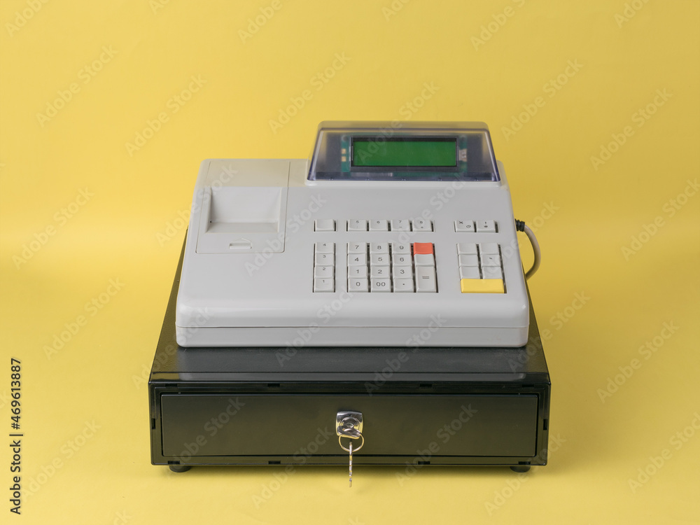 Cash register close-up on a yellow background. Cash register close-up on a yellow background.