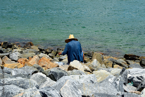 Fisherman preparing to fish on rock seawall in Cape Canaveral