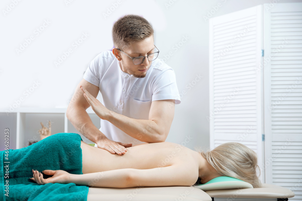 Fototapeta premium Doctor osteopath use therapy for woman in clinic. Concept physiotherapy massage for rehab sport injury athlete back