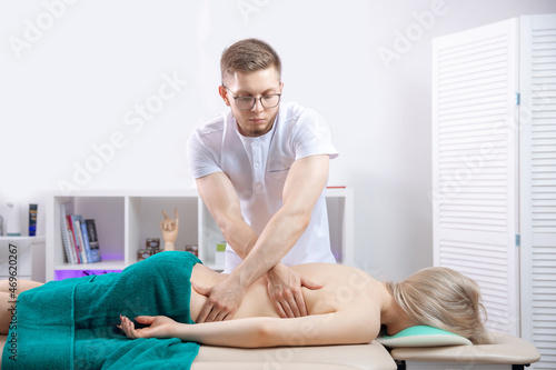 Concept physiotherapy massage for rehab sport injury athlete back. Doctor osteopath use therapy for woman in clinic © Parilov