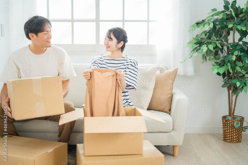 ダンボールの中の洋服を持つ男女(引越し)
ダンボールの中の洋服を持つ男女(引越し)