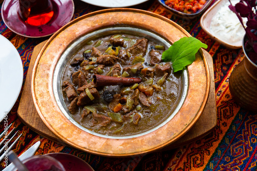 Mutancana, one of popular dishes of Ottoman Palace Cuisine from lamb with sweet dried fruits, honey and almonds photo