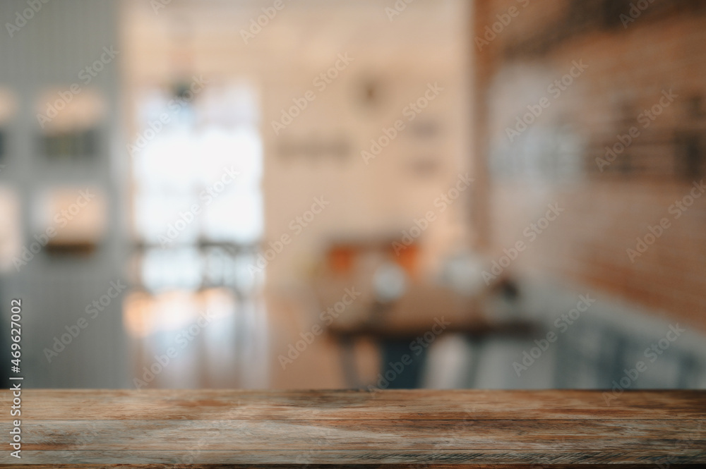 Empty wooden table with blurred coffee shop in background. For display or montage your products. Empty wooden table with blurred coffee shop in background. For display or montage your products.