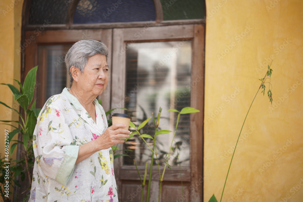 old elderly senior elder woman drinking hot coffee in garden old elderly senior elder woman drinking hot coffee in garden