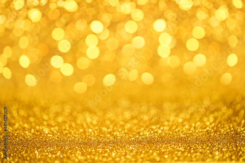 Golden glitter lights sparkling bokeh abstract background with defocused lights Christmas.