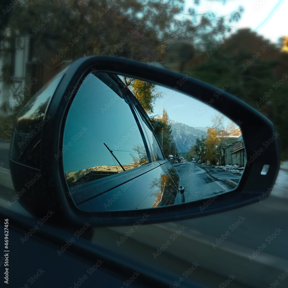 landscape in the reflection of the car