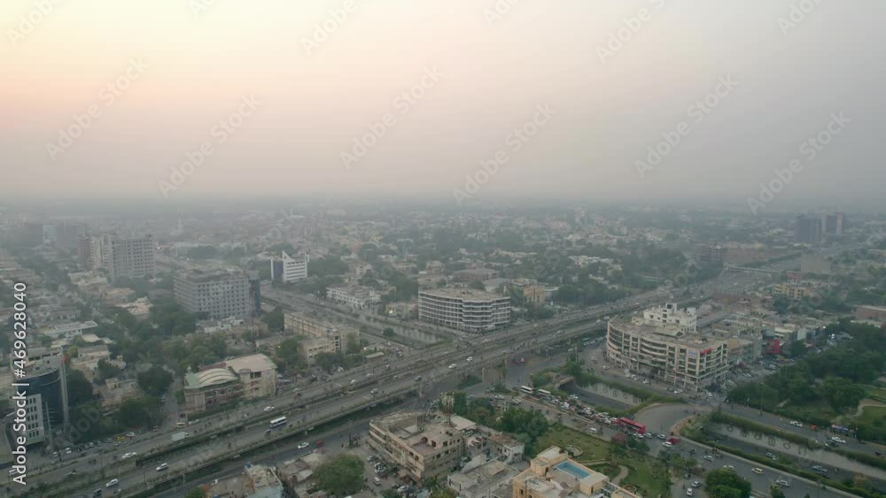 Tracking Aerial Shot Of Cars Commuting On A Busy Highway, Urban Cityscape Tracking Aerial Shot Of Cars Commuting On A Busy Highway, Urban Cityscape