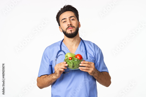 Cheerful dietitian with vegetables in hands vitamins healthy food