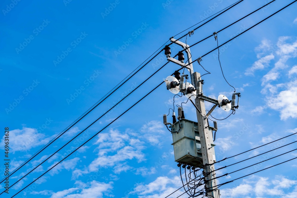 Electric pole and blue sky. Power and energy. Three-phase electric power for transfer power by electrical grids. Global energy crisis concept. Clean energy. Green power for sustainability energy. Electric pole and blue sky. Power and energy. Three-phase electric power for transfer power by electrical grids. Global energy crisis concept. Clean energy. Green power for sustainability energy.