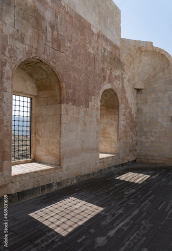 Wall of an old palace with window openings and beautiful shadows