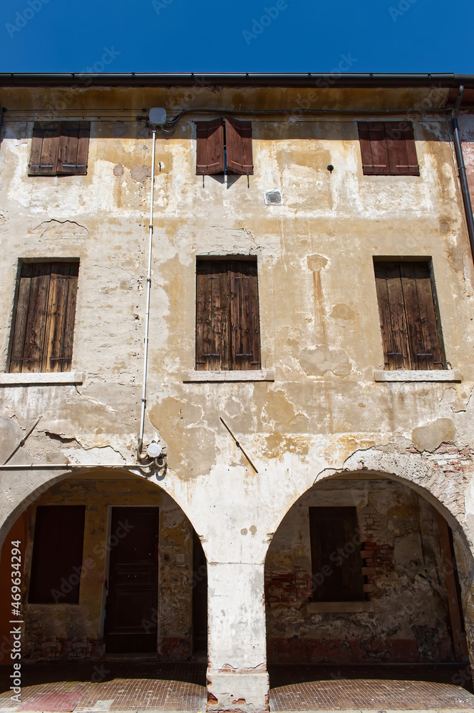 Facade of an ancient medieval building in the town of Cittadella. Padova, Italy.