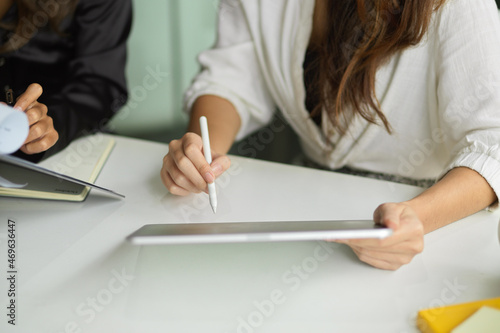Close-up businesswoman hands using stylus pen with modern tablet computer