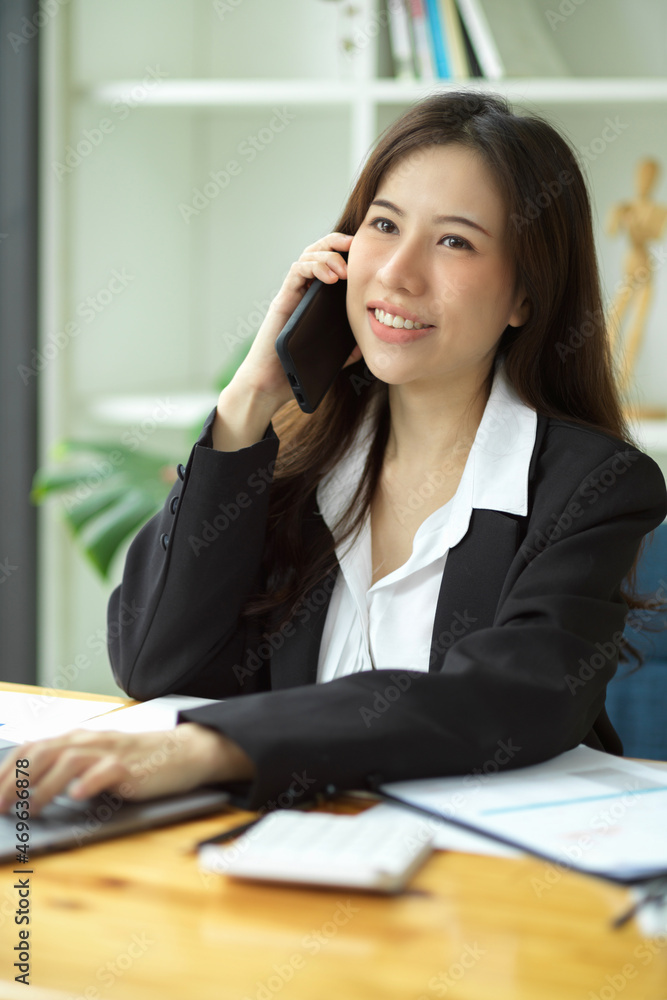 Portrait of Attractive female assistant talking on the phone Portrait of Attractive female assistant talking on the phone