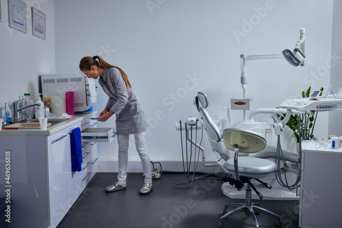 Caucasian female dentist working in her office