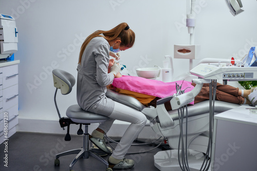 Dentist examining the teeth of a young woman