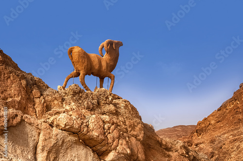 Mountain oasis Chebik, Sahara Desert, mountain peak in the desert with a sculpture of a mountain goat.