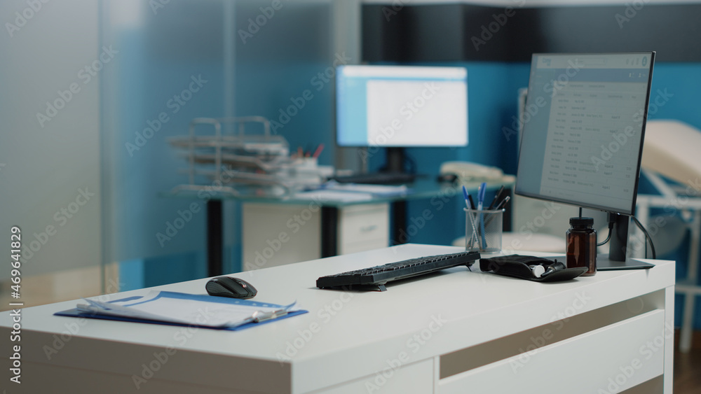 Nobody in doctors office with medical equipment and tools. Empty cabinet with computer, healthcare instruments, checkup documents and papers on desk. Office for consultation at facility