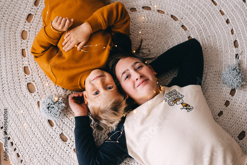 two boys lying at the carpet