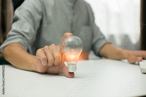 Light bulb Energy saving and pig piggy bank a coin glass on the floor white background