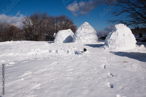 View of human built igloos in a winter landscape in Italy with beautiful sky © Fabien
