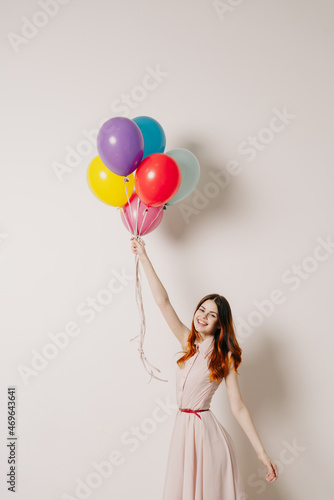 cheerful woman in a dress of colorful balloons