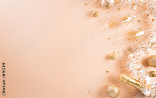 Happy New year celebration background concept. Golden gift box, stars, christmas ball and champagne on pastel background.