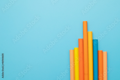 educational direction concept colored pencils on a blue background