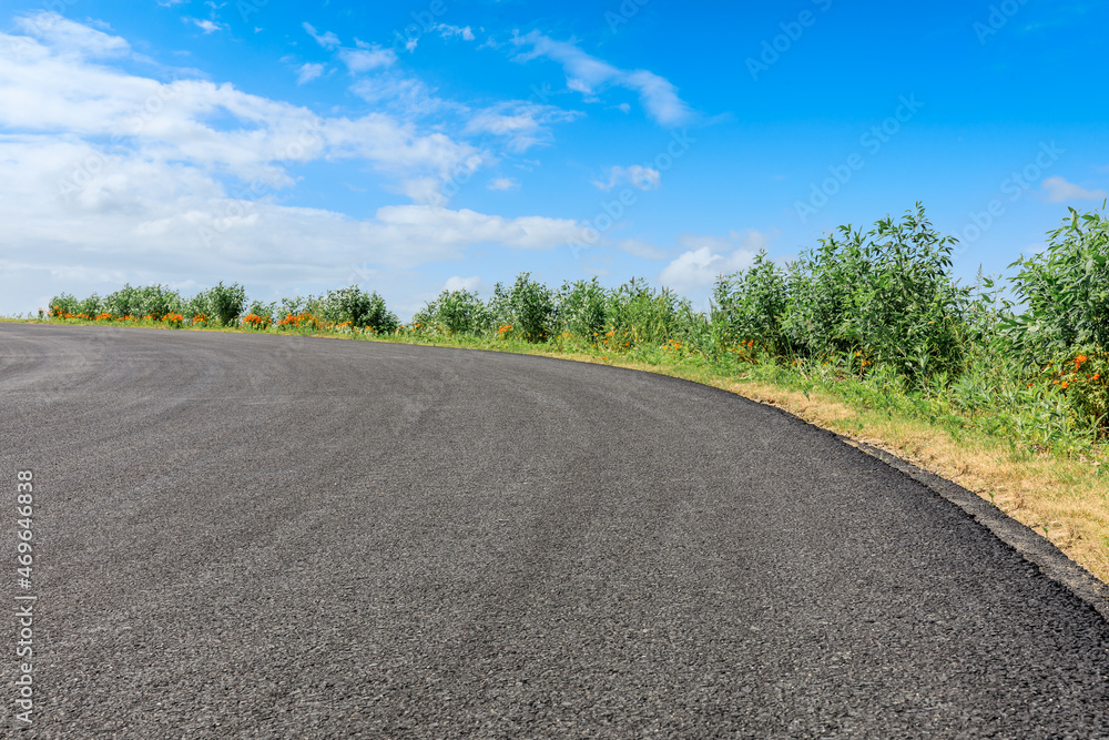 Empty asphalt road and blue sky with white clouds.
