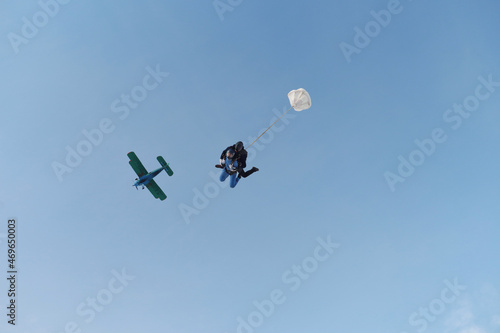 Skydiving. Tandem jump. An instructor and a girl are in the sky.