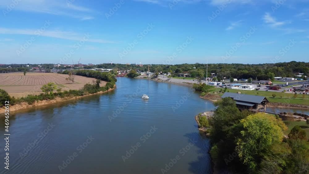 White Boat Cruising In The River Towards Harbor At Daytime. - aerial White Boat Cruising In The River Towards Harbor At Daytime. - aerial