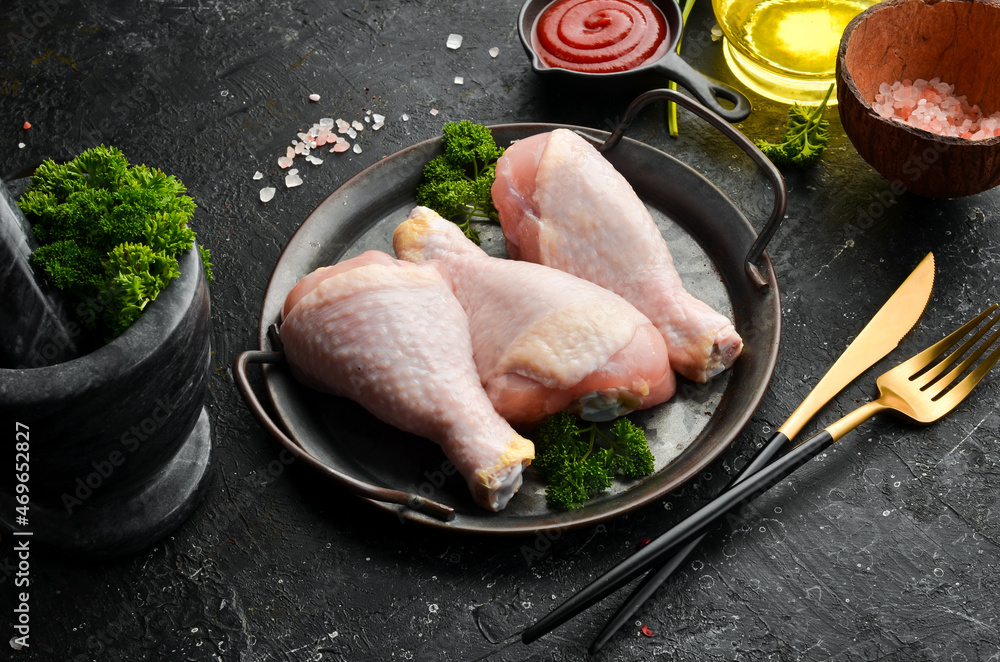 Chicken meat. Raw fresh chicken drumsticks on black slate stone background. Top view. Raw meat. Chicken meat. Raw fresh chicken drumsticks on black slate stone background. Top view. Raw meat.