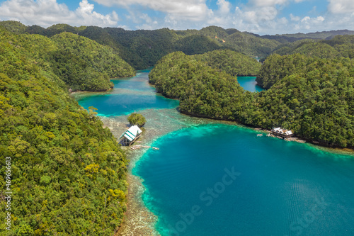 Tropical sea bay and lagoon, beach in Bucas Grande Island, Sohoton Cove. Philippines. Tropical landscape hill, clouds and mountains rocks with rainforest. Azure water of lagoon.