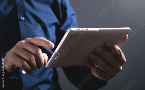 Businessman using white digital tablet.