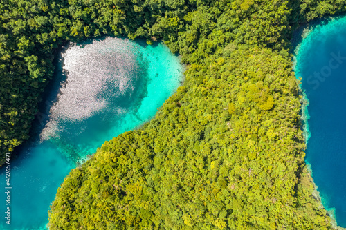 Tropical forest covered limestone around clear blue lagoons. Drone view of famous beautiful destination in Socorro Philippines, Sohoton Cove in Bucas Grande, Siargao. Best places in asia. photo