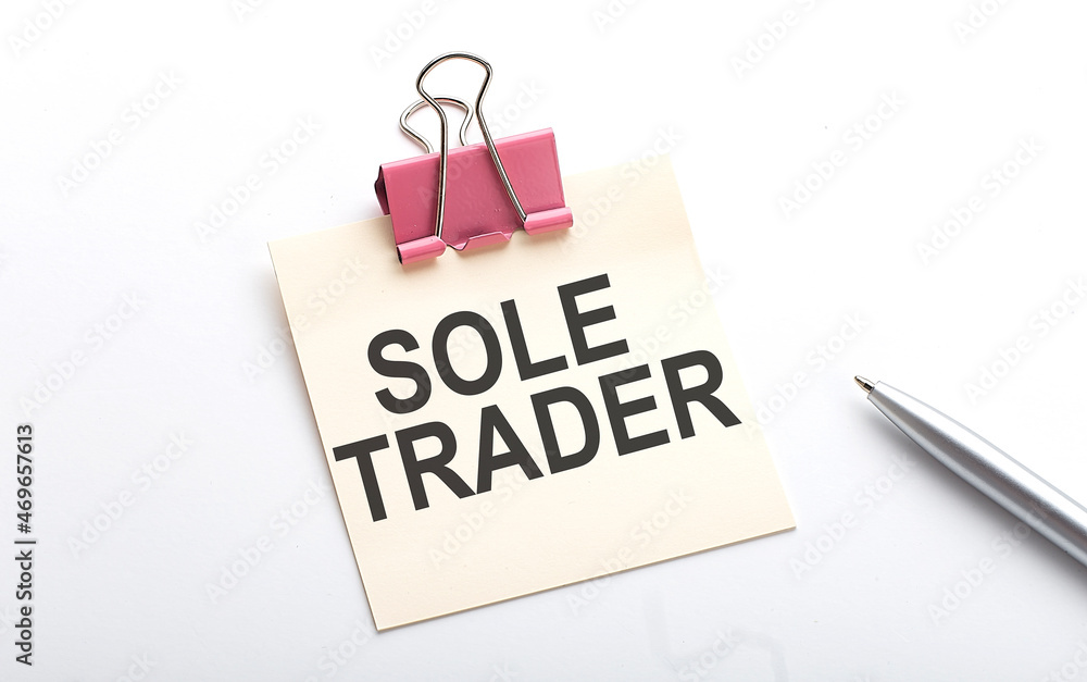 SOLE TRADER text on the sticker with pen on white background SOLE TRADER text on the sticker with pen on white background