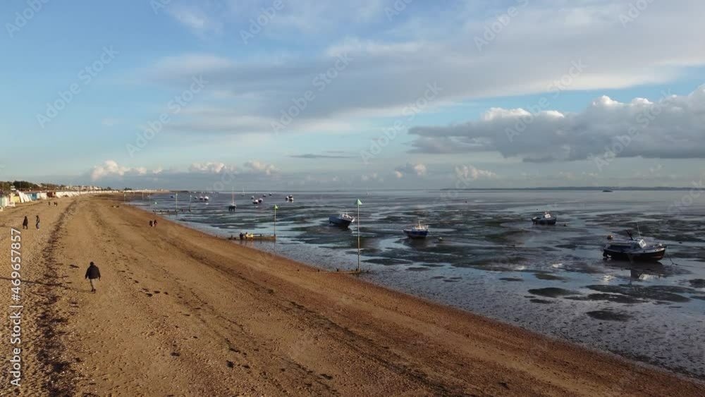 Walk on Southend beach during a beautiful autumn day in golden light and boats in the sea at low tide. Drone aerial view
Walk on Southend beach during a beautiful autumn day in golden light and boats in the sea at low tide. Drone aerial view