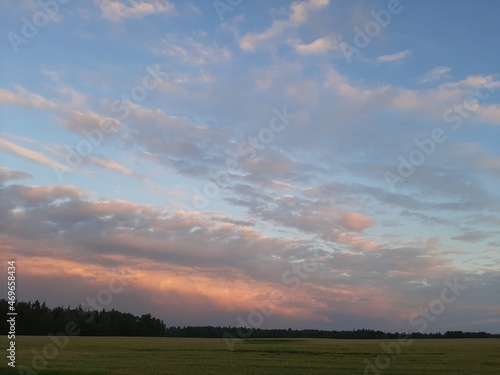 Beautiful summer sunset. Sunset over the field. Beautiful sunset sky. Beautiful clouds in the sky.