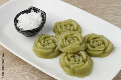 Kue Lumpang Pandan or Kue IJo, Indonesian traditional food with springy texture, made from sago flour and rice flour, sugar and pandan. Served in white plate, selective focus image.
 photo