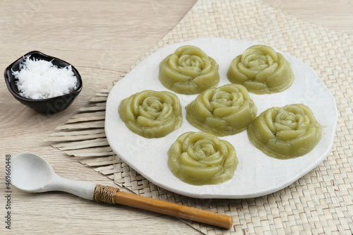 Kue Lumpang Pandan or Kue IJo, Indonesian traditional food with springy texture, made from sago flour and rice flour, sugar and pandan. Served in white plate, selective focus image.
 photo