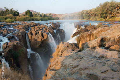 View of Epupa falls at sunset. Forest in the background. Namibia